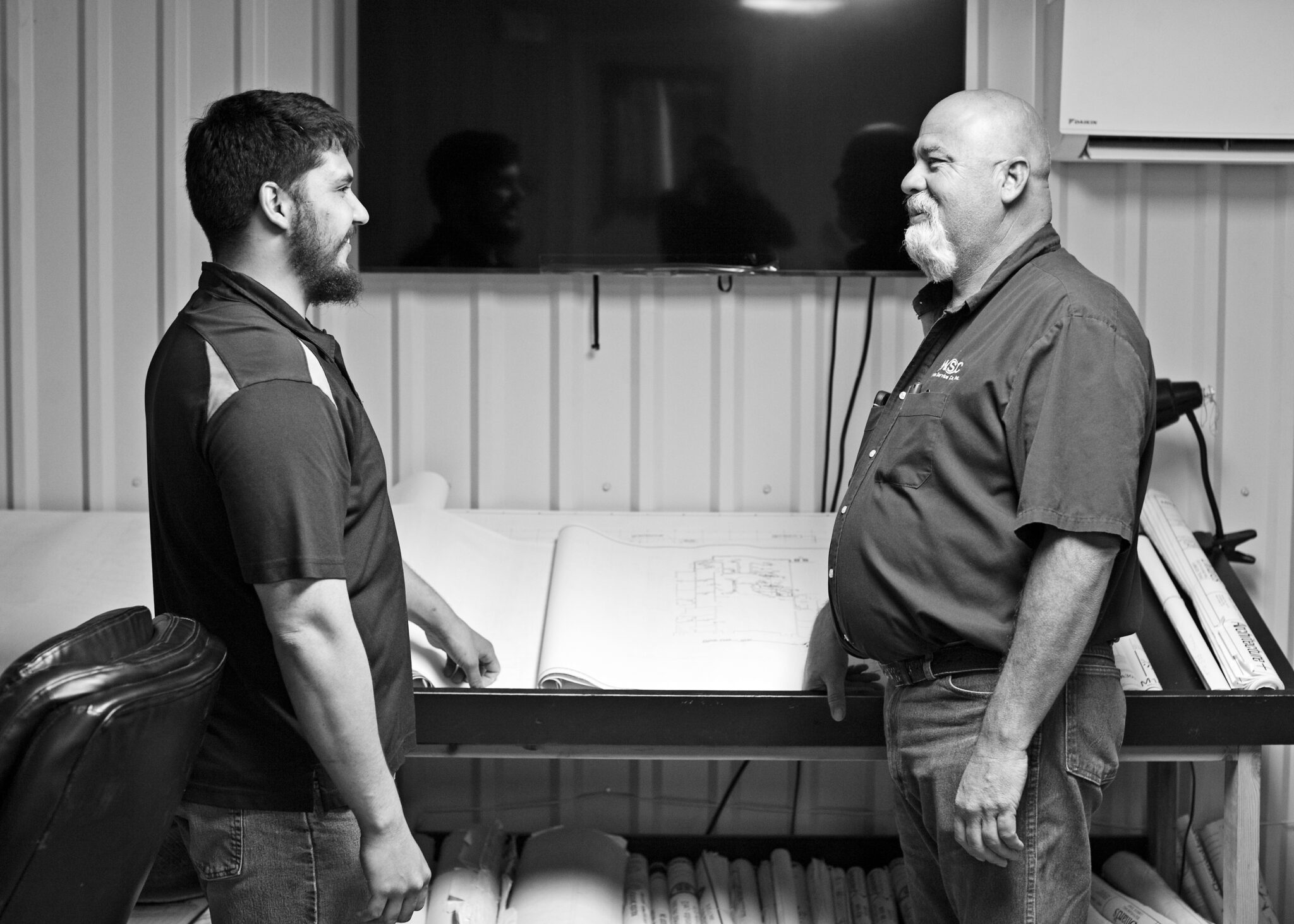 two team members looking at building plans